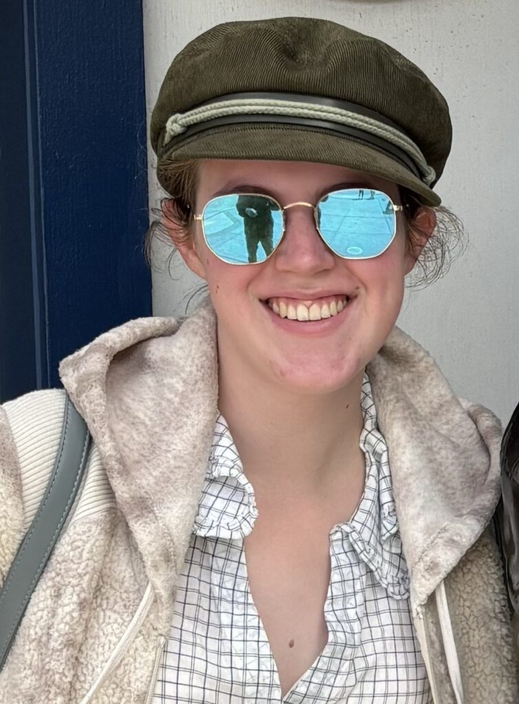 Photo of a young woman wearing mirrored sunglasses