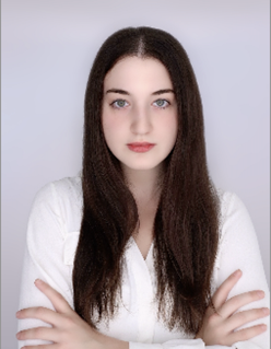 The author, a young woman with long brown hair and wearing a white sweater, faces the camera. 
