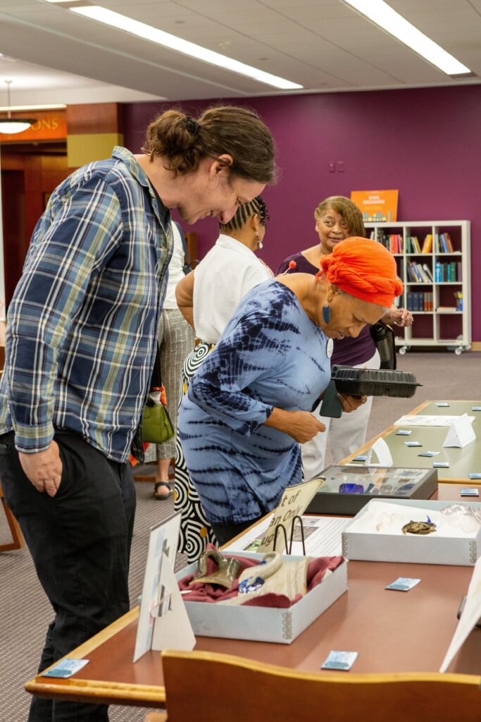 Mary Lassiter views artifacts from the Reservation. Photo by Sara Belmont, William & Mary Libraries.